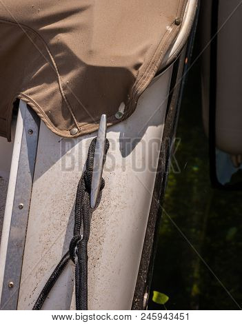 Dock Cleat On The Side Of A Boat In A Small Marina, An Element Of Yachting Equipment