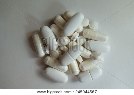 Heap Of White Magnesium Citrate Capsules, Calcium Citrate Caplets And Vitamin K2 Tablets