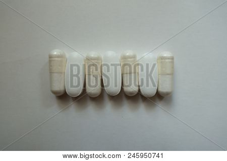 Pills Of Calcium Citrate And Capsules Of Magnesium Citrate In A Row