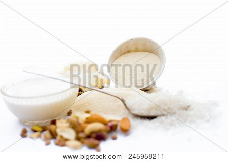 Entire Ingredients For Suji Ka Halwa Isolated On White Including Milk And Dry Fruits.