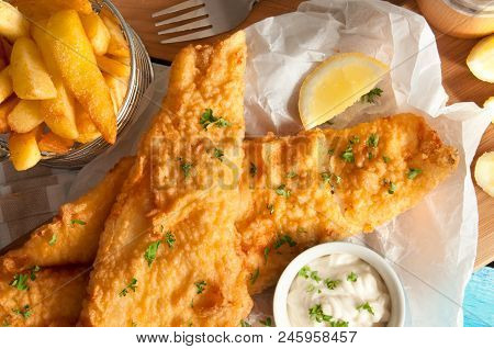 Close Up Of Battered Fish And Chips With Mayonnaise Sauce