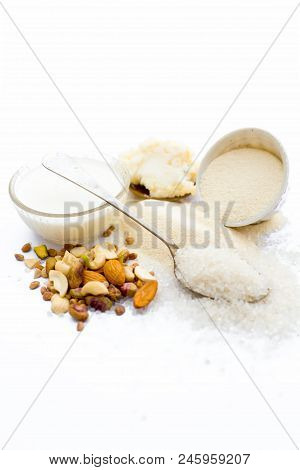 Entire Ingredients For Suji Ka Halwa Isolated On White Including Milk And Dry Fruits.