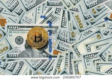 Golden Metal Bitcoin On Dollar Bills Background. A Lot Of Money In Cash. 100 Dollars Texture. Dear B
