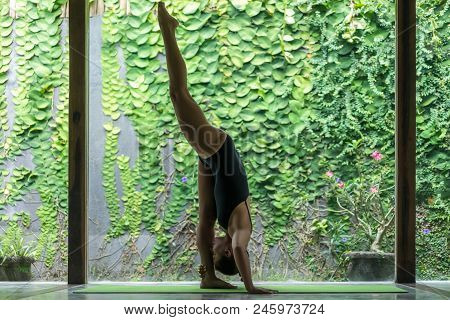 Side View Of Beautiful Young Woman Practicing Yoga In Standing Splits Pose Urdhva Prasarita Eka Pada