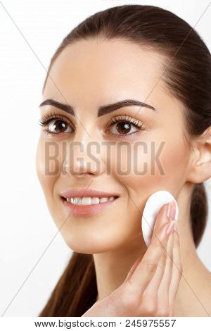 Skin Care. Beautiful Happy Woman Removing Face Makeup Using Cotton Pad. Closeup. Portrait Of Woman S