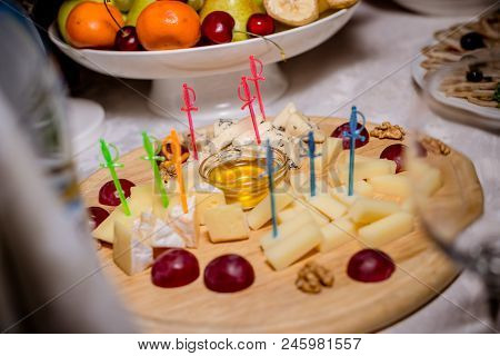 Still-life Cheese Platter With Nuts And Grapes