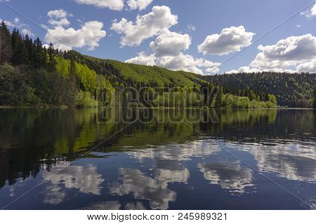 Landscape - River With Beautiful Wooded Shores And Sky With Clouds Reflecting In The Water