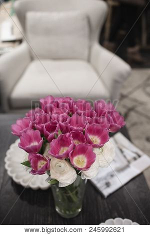 Pink Flowers Stand On A Wooden Table