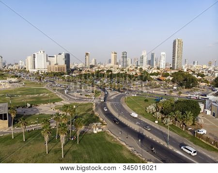 Aerial Panoramic View Of Tel Aviv. City Buildings, Well Planned Transport Junction Of Highways, Gree