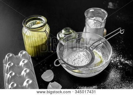 Ingredients For Home Baking: Cookies, Bread, Cake. Flour, Sugar, And Eggs Are On The Black Table. Ba