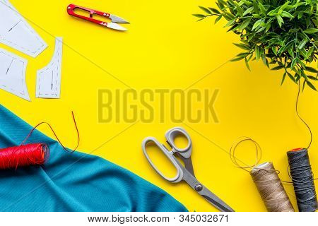 Sewing Wokrshop. Textile, Pattern, Scissors, Thread On Yellow Background Top-down Copy Space
