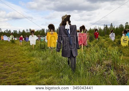 Suomussalmi, Finland - July 24, 2019: View To The Group Of Objects In People Clothes Which Looks Lik