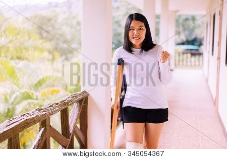 Asian Woman Patient Using Crutches And Broken Legs For Walking At Hospital
