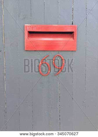 Typical Australian Mail Box Integrated In Wooden Door With The Number 69. Can Be Used As Conceptual 