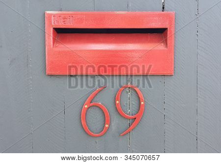 Typical Australian Mail Box Integrated In Wooden Door With The Number 69. Can Be Used As Conceptual 
