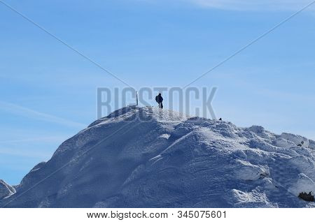 Lone Wolf On The Peak Of Chopok In Low Tatras In Slovakia, Europe. Snowy Hill And Man With Rucksak S