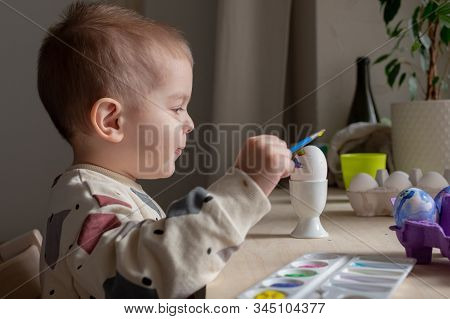 Toddler Boy Painting Easter Eggs Preparing For Holidays. Easter Tradition
