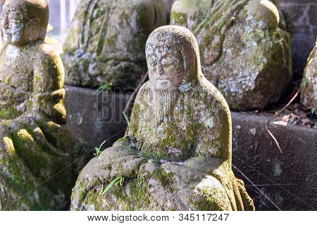 Statue Of A Seated Buddhist Monks Made Of Stone Close-up