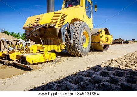 Vibration Plate Compactor Is Mounted To The Steamroller, Compacting Sand At Road Construction Site.