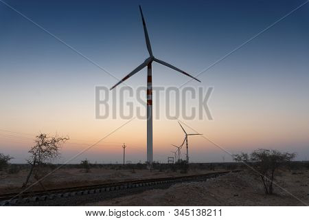 Wind Mills Before Dawn With Pre Dawn Light In The Sky In Background, Thar Desert, Jaisalmer, Rajasth