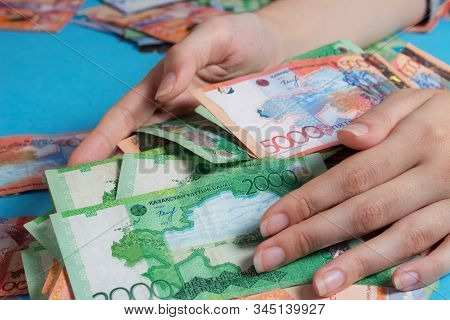 Hands Hold A Lot Of Tenge.kzt. National Currency Of Kazakhstan, Kz. Exchange Rate. Economy, Developm