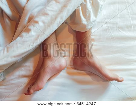 Top View Of Both Legs On The White Bed, Both Legs On A Bed Of White.