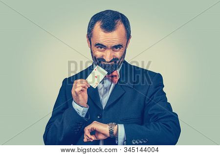 Bearded Businessman Showing Ace Card And Watch, Looking Sly To You Camera. Win Now. Right Time For B