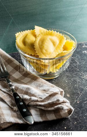 Italian stuffed pasta. Panzerotti pasta in bowl on old kitchen table.