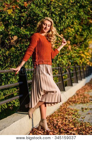 Cute Smiling Woman. Sunny Day With Leaves. Fall Fashion Season. Girl In Corrugated Skirt And Sweater