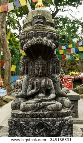 Ancient Carved Stone Pillar With The Image Of A Sitting Buddha And Are Decorated With Traditional Bu