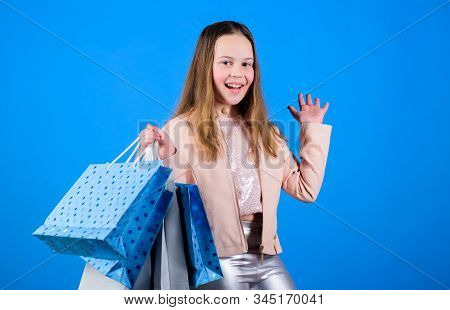 Kid Fashion. Shop Assistant With Package. Sales And Discounts. Small Girl With Shopping Bags. Happy 