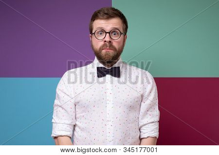 Strange, Excited Bearded Man In Round Glasses And A Bow-tie, Stands Motionless And Looks Into The Ca