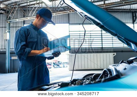 Car Mechanic Holding Clipboard And Checking To Maintenance Vehicle By Customer Claim Order In Auto R