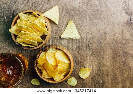 Table Fof Tasty Snacks And Beer Prepared For Watching Sports On Tv. Wooden Background. Top View. Fla