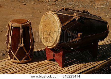 Dholak, Two Traditional Musical Instruments On Bamboo And Wooden Coasters