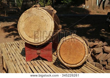 Front View Of The Dholak Music Instrument, Two Traditional Musical Instruments On Bamboo
