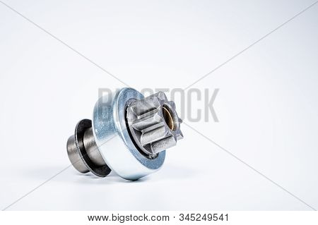 New Spare Parts - Starter Gear Drive For Motor Starter On A Gray Background. Classic Gear Transmissi
