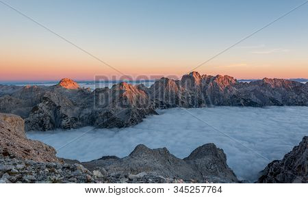 Spectacular Morning Mountain Panorama With Mists Covering A Valley.