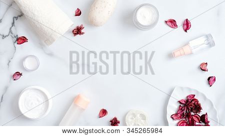 Natural Cosmetic Products And Rose Petals On Marble Background. Frame Made Of Towel, Handmade Soap, 