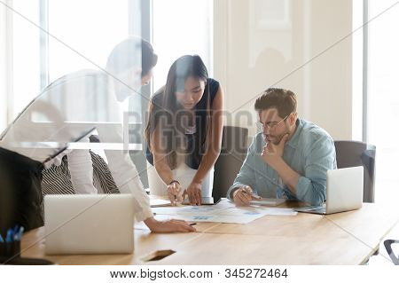 Multiethnic Colleagues Discuss Business Project Ideas At Briefing