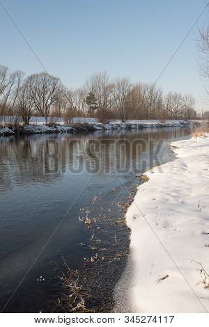 Olse River In Karvina Town In Czech Republic During Winter Day With Snow And Clear Sky