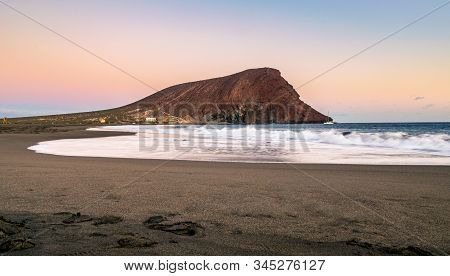 Tenerife, Spain - December 21, 2019: Sunset At La Tejita Beach With The Iconic 