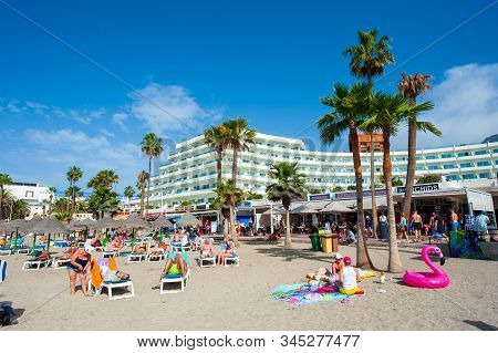 Canary Island Tenerife, Spain - 26 Dec, 2019: Tourists Are Relaxing On Playa La Pinta Puerto Colon. 
