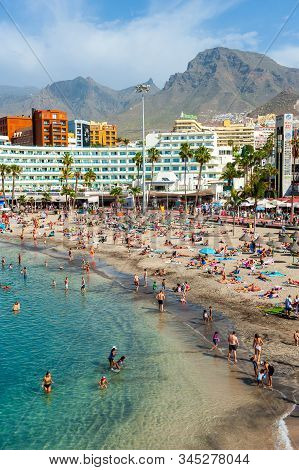 Canary Island Tenerife, Spain - 26 Dec, 2019: Tourists Are Relaxing On Playa La Pinta Puerto Colon. 