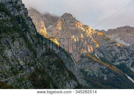 Morning Sun Illuminating A Lush Mountain Valley.