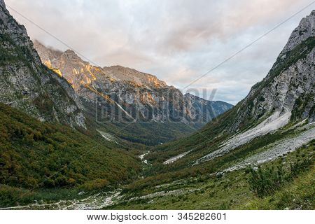 Morning Sun Illuminating A Lush Mountain Valley.