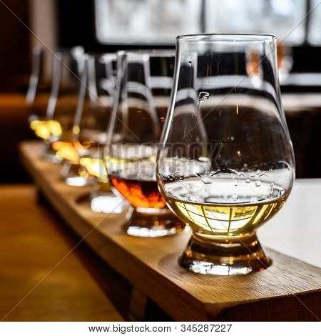 Scotch Whisky, Tasting Glasses With Variety Of Single Malts Or Blended Whiskey Spirits On Distillery