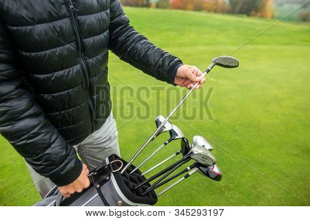 Professional Golf Player Choosing The Golf Club From The Bag