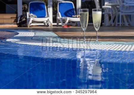 Pool Party With Two Glasses Of Bubbles White Champagne Or Cava Wine, Romantic Event On All Inclusive