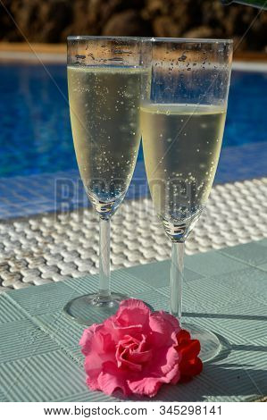 Pool Party With Two Glasses Of Bubbles White Champagne Or Cava Wine, Romantic Event On All Inclusive